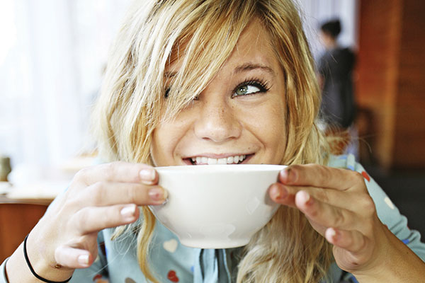 woman smiling with mug